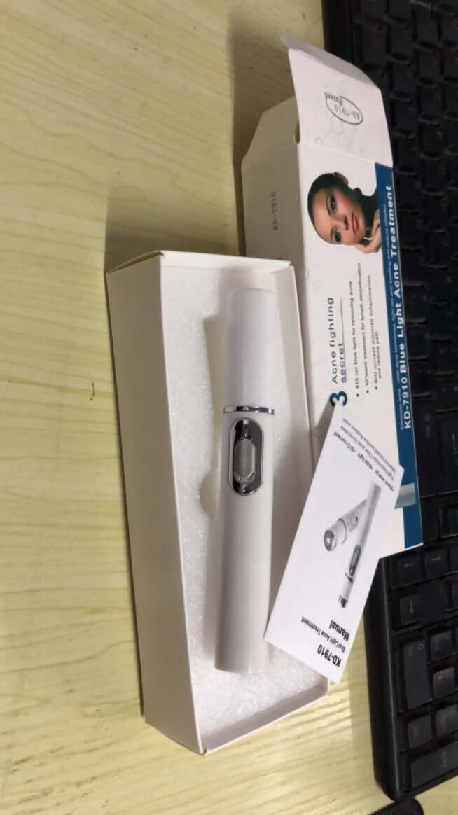 Blue light therapy laser pen for acne treatment, scar reduction, and skincare maintenance, placed in a box with instructions.